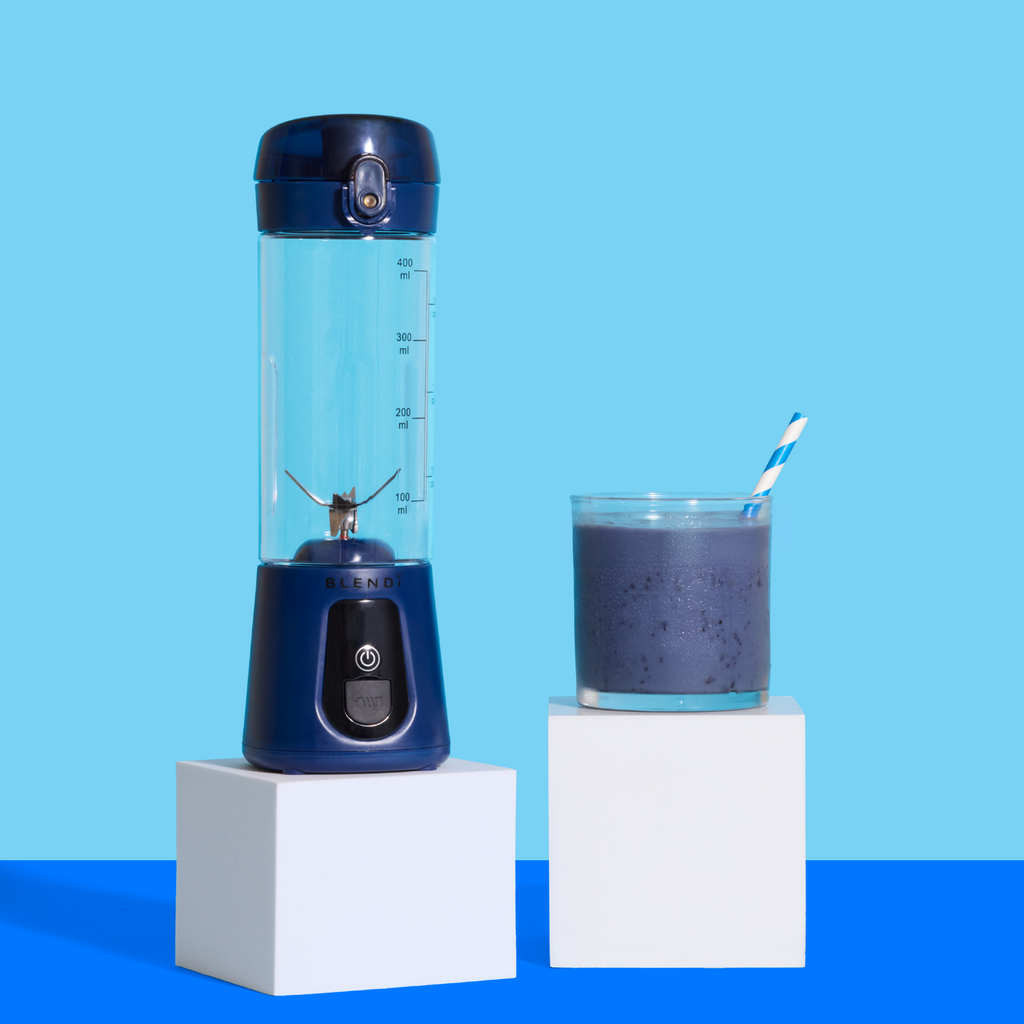 Blue Pro+ 17oz portable ice-crushing blender beside a purple smoothie, compact personal blender for smoothies, shakes and frozen drinks.