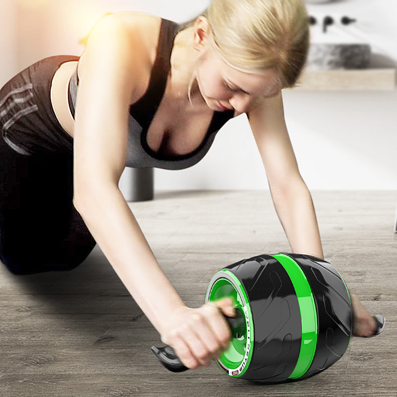 Woman exercising with an ab roller on a wooden floor.