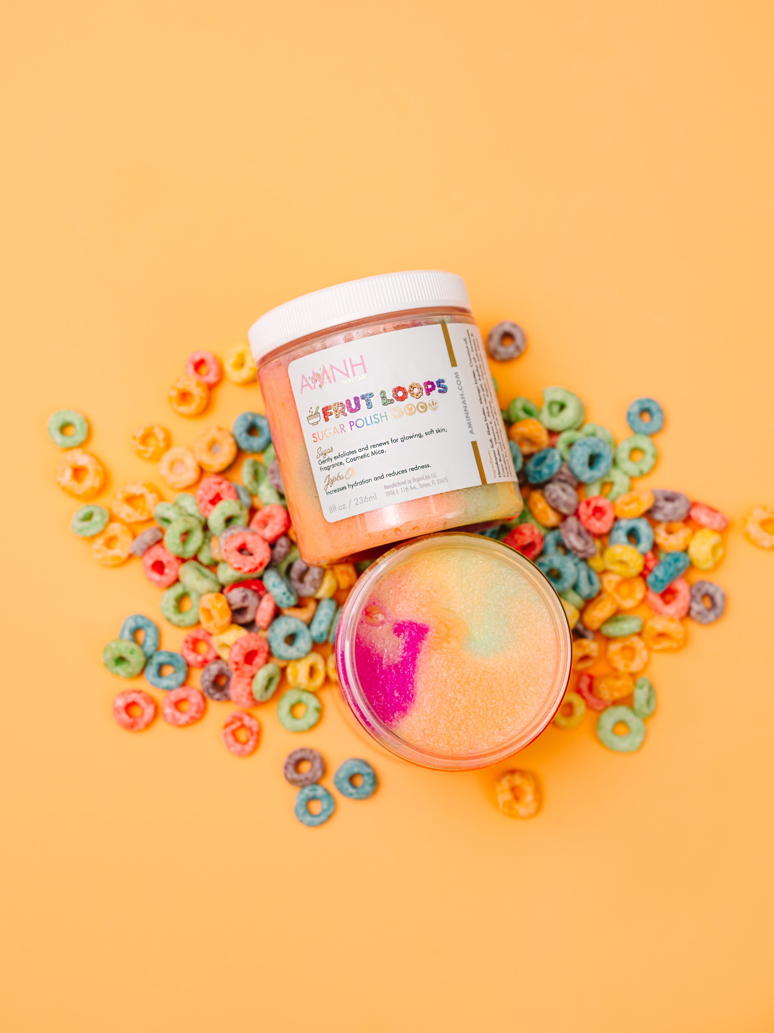 AMINNAH Frut Loops Sugar Scrub made with real sugar, shea butter, mango butter, cocoa butter, coconut oil, jojoba oil, aloe vera, and vitamin E. Fruity scented exfoliating body scrub for soft, smooth, hydrated skin from a female-owned clean beauty brand.