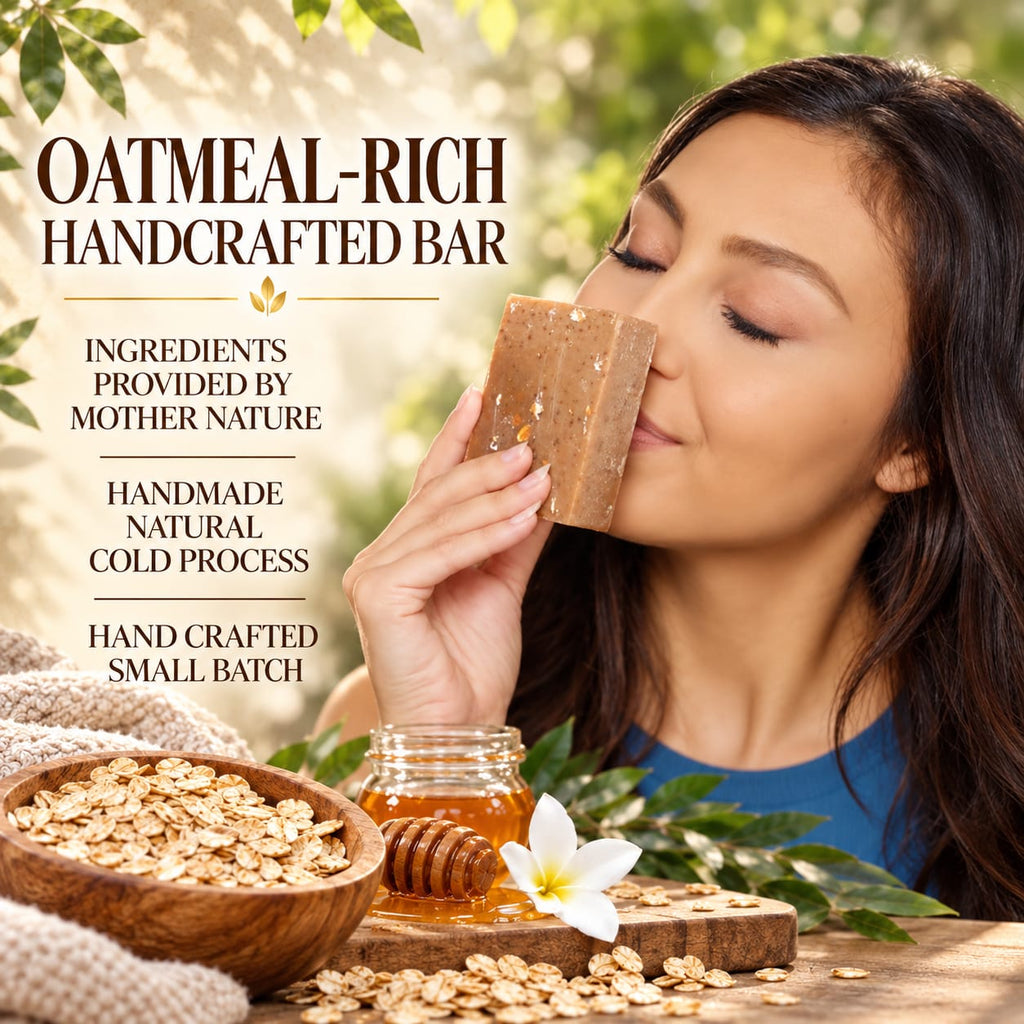 A woman holds a rectangular oatmeal bar soap close to her nose in a warm, natural setting. The scene includes text reading 'OATMEAL-RICH HANDCRAFTED BAR' and supporting claims, with oats, honey, a flower, and leaves around the product.