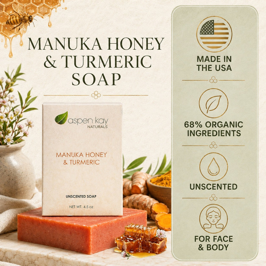 Aspen Kay Naturals Manuka Honey & Turmeric Unscented Soap bar shown on a marble surface with honeycomb, ginger, and flowers. The product box is centered, with a vertical informational panel on the right reading 'Made in the USA,' '68% Organic Ingredients,' 'Unscented,' and 'For Face & Body.