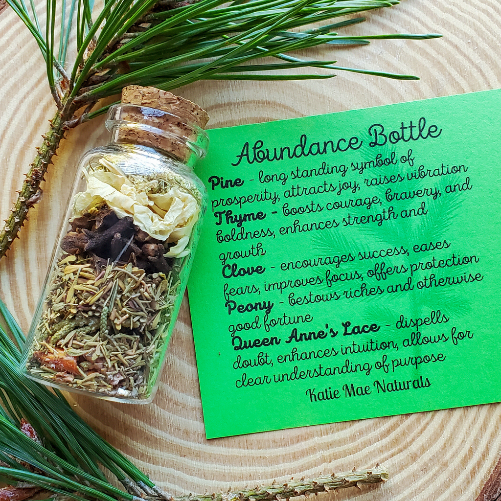 Glass bottle with dried herbs on a wooden surface with a green label