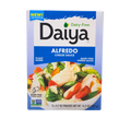 Daiya Dairy-Free Alfredo Cheese Sauce box with plant-based, non-GMO Alfredo sauce pouches, 14.2 oz (3 x 4.7 oz), displayed on a transparent background. This product is a NON-GMO Project Verified cheese source.