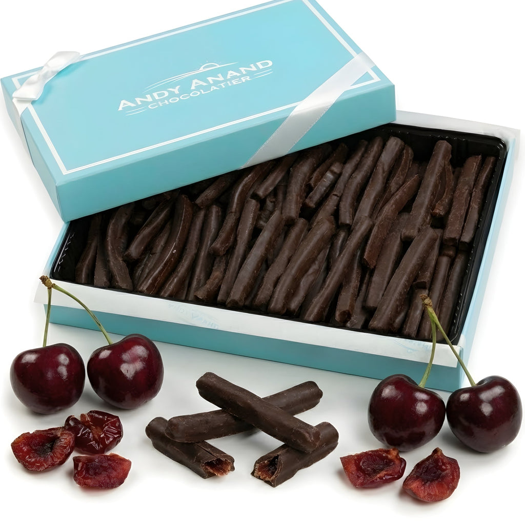 Box of Andy Anand Chocolates with chocolate-dipped cherries and dried cranberries on a white background