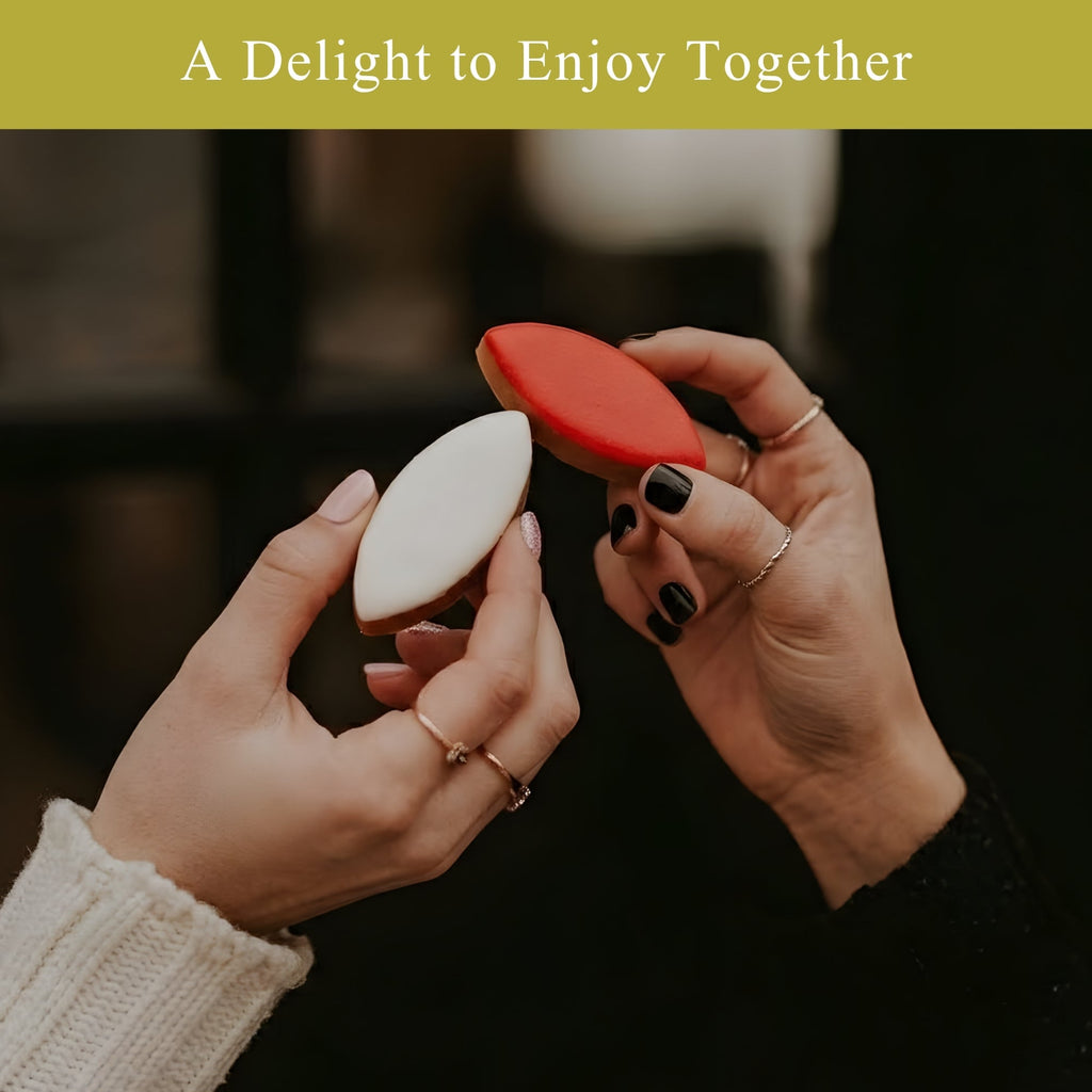 Two hands holding a red and white cookie with text 'A Delight to Enjoy Together' on a dark background