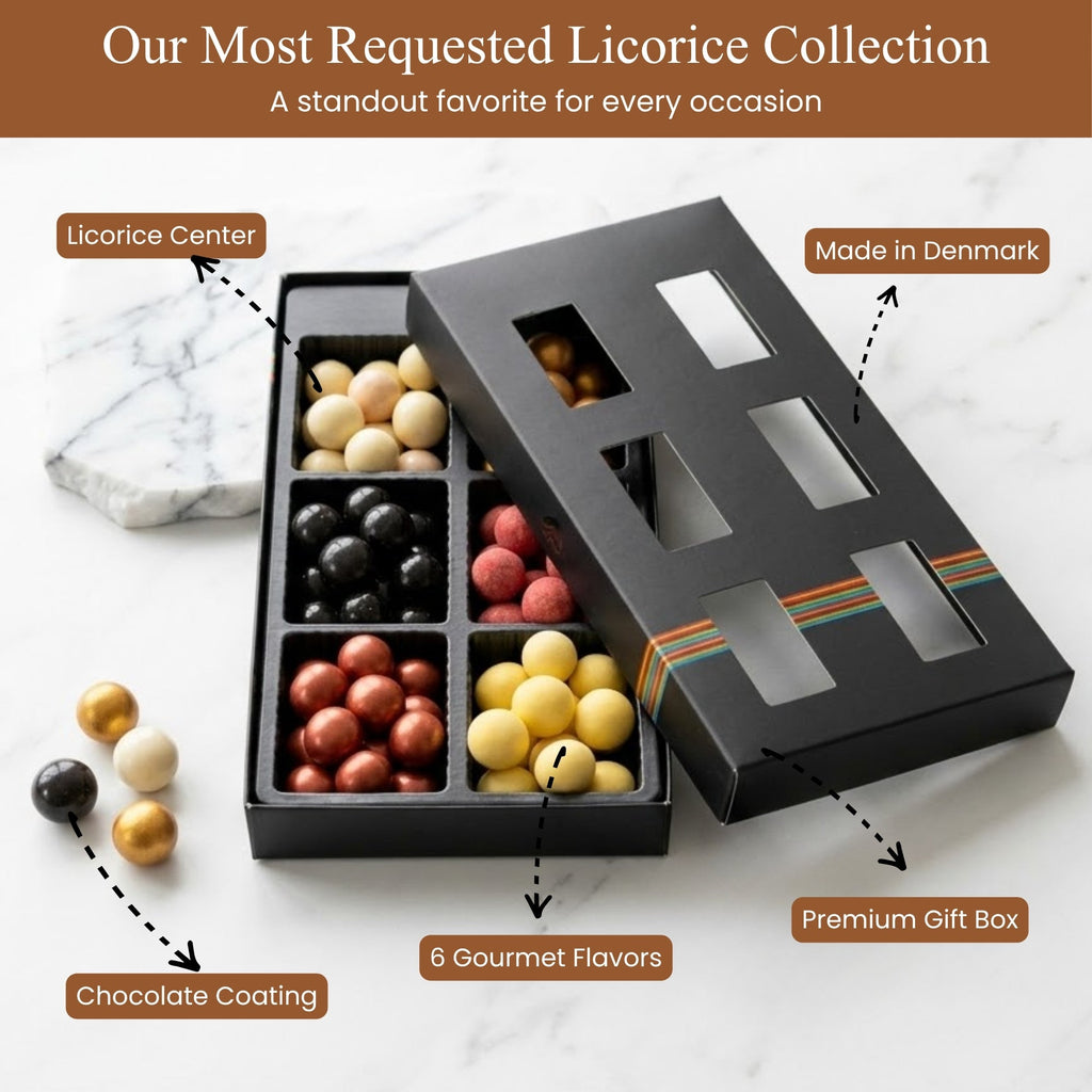 Black gift box with licorice pieces in various flavors on a marble surface.
