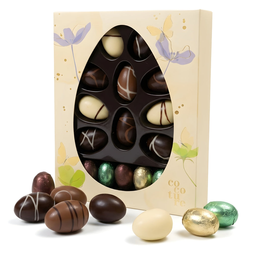 Easter egg-shaped chocolate box with assorted chocolates on a white background