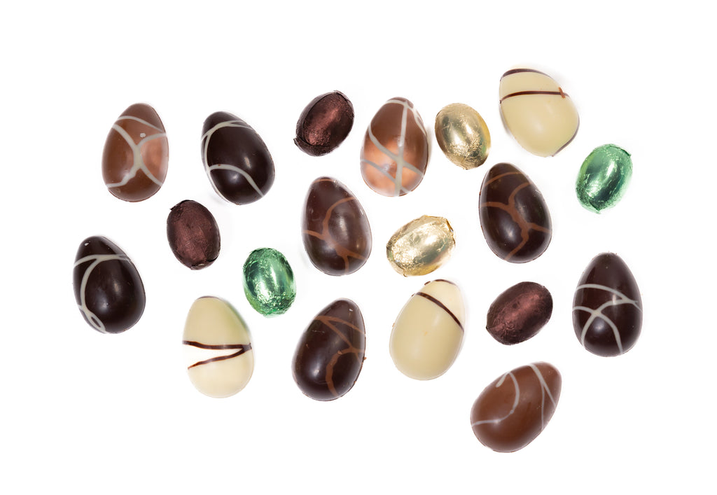 Assorted chocolate eggs with different colors and patterns on a white background