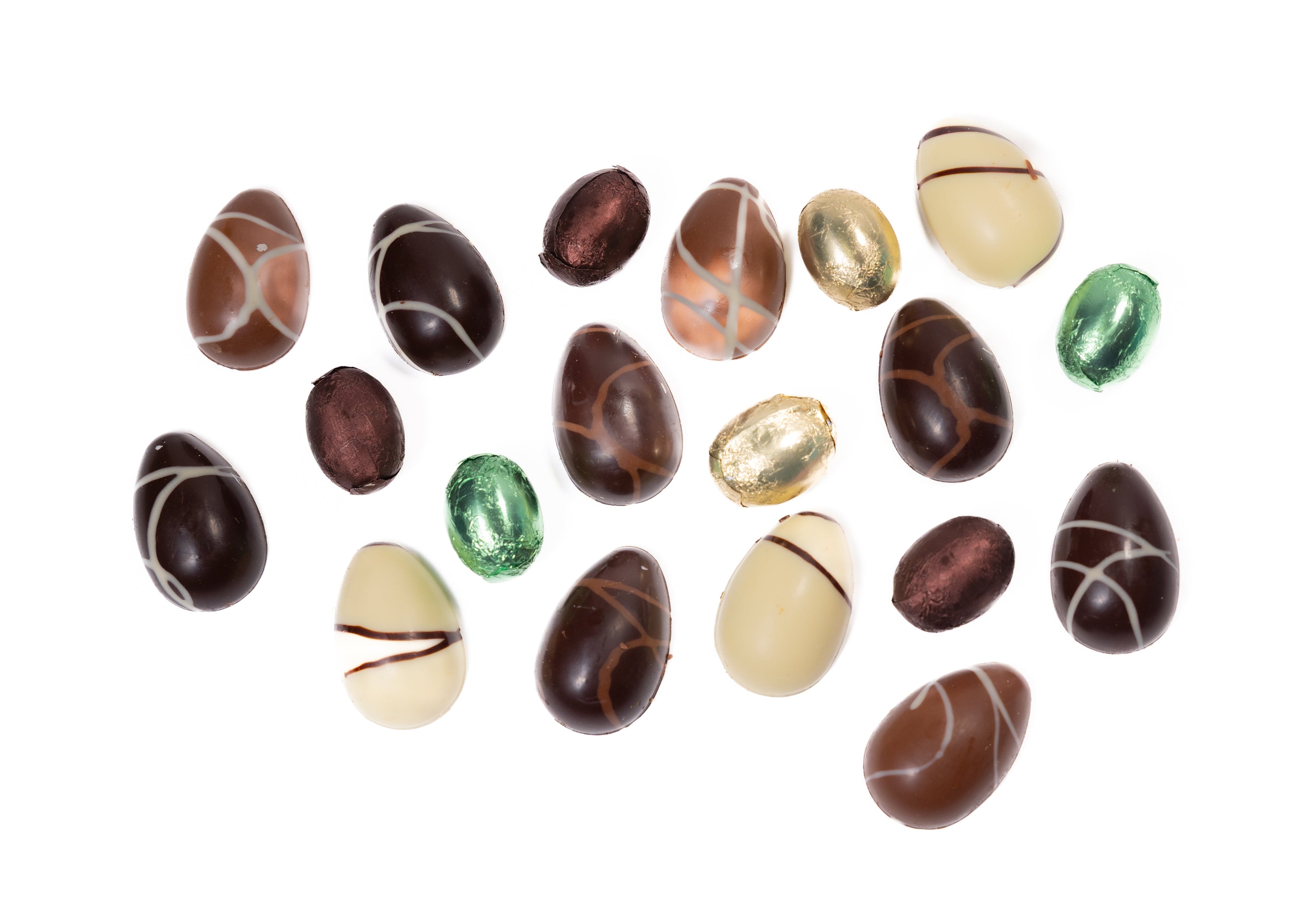 Assorted chocolate eggs with different colors and patterns on a white background