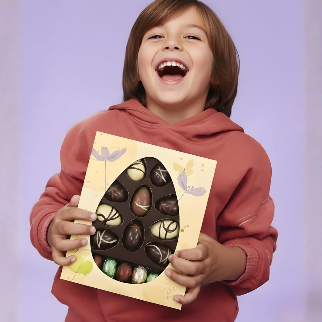 Child holding a box of chocolates with a purple background