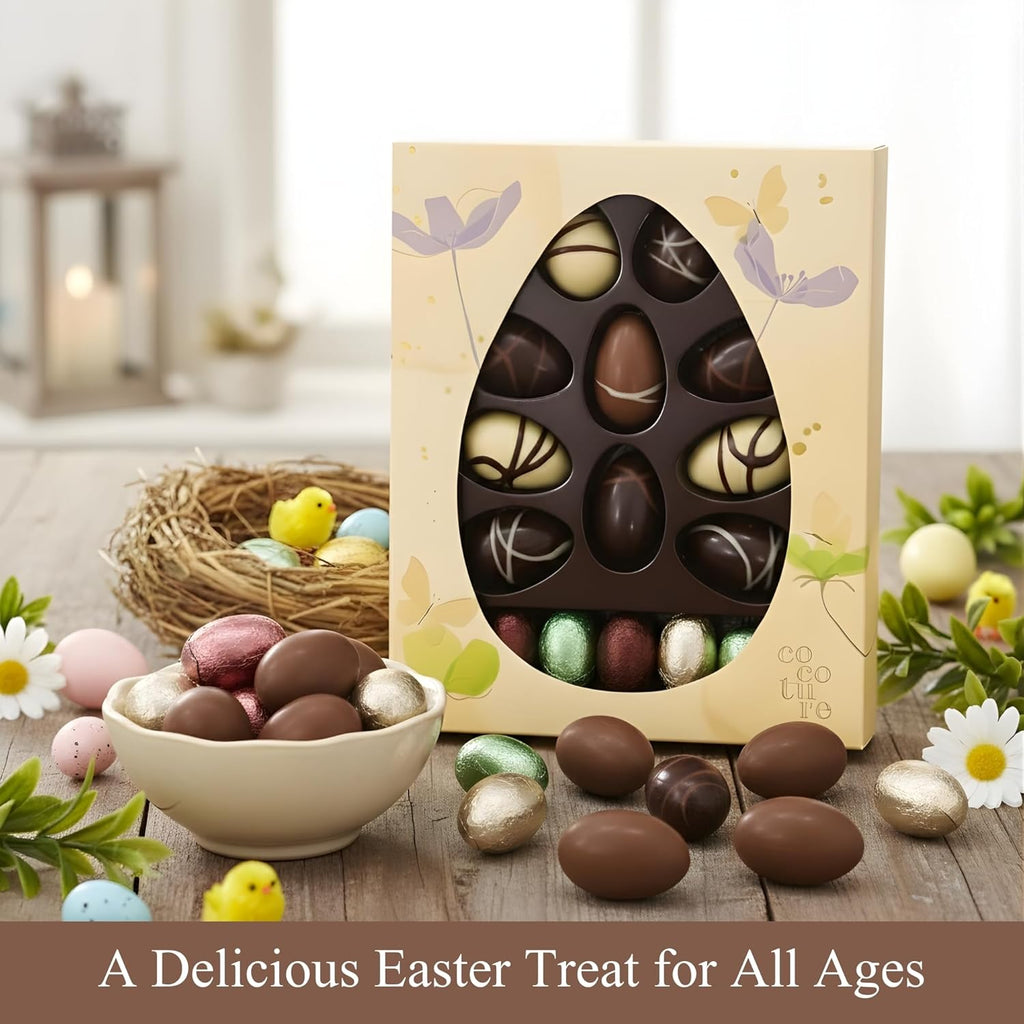 Easter-themed chocolate eggs in a decorative box with a bowl of assorted Easter eggs on a wooden table.