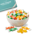 Bowl of colorful sugar-free candies with a box labeled 'Andy Anand Chocolatier' in the background.