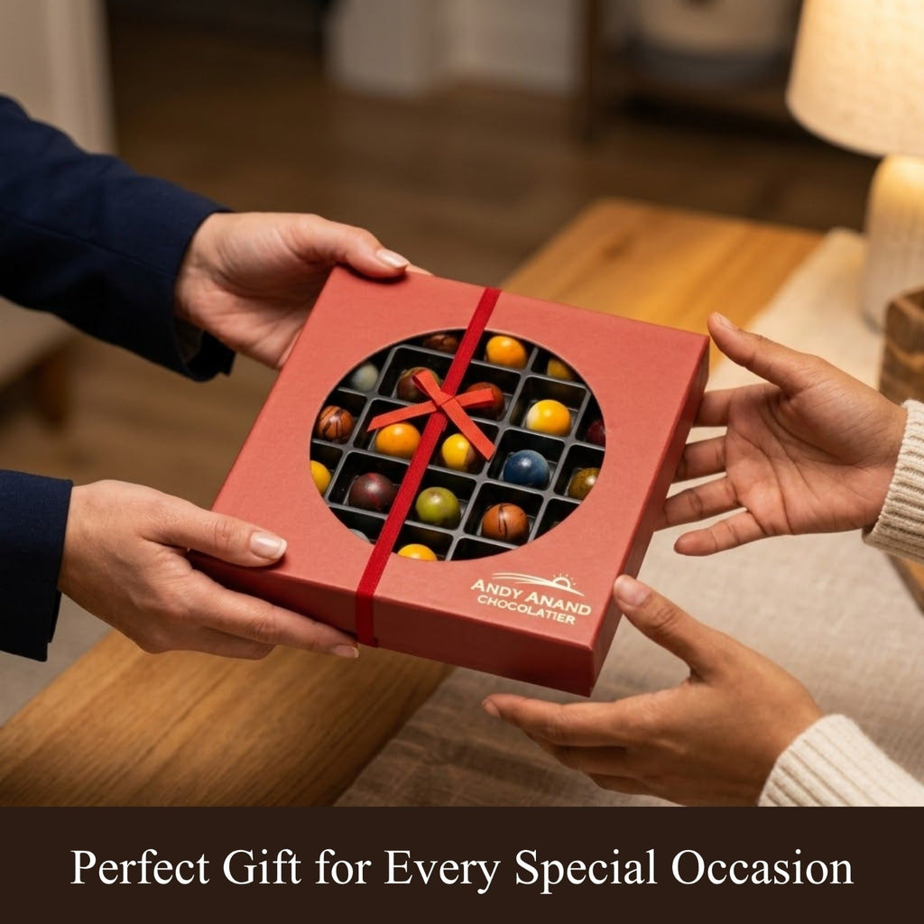 Two hands exchanging a red box of chocolates with a visible brand name, set against a blurred indoor background.