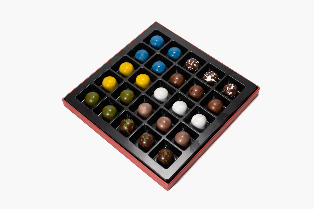 Assorted colorful chocolates in a grid on a white background