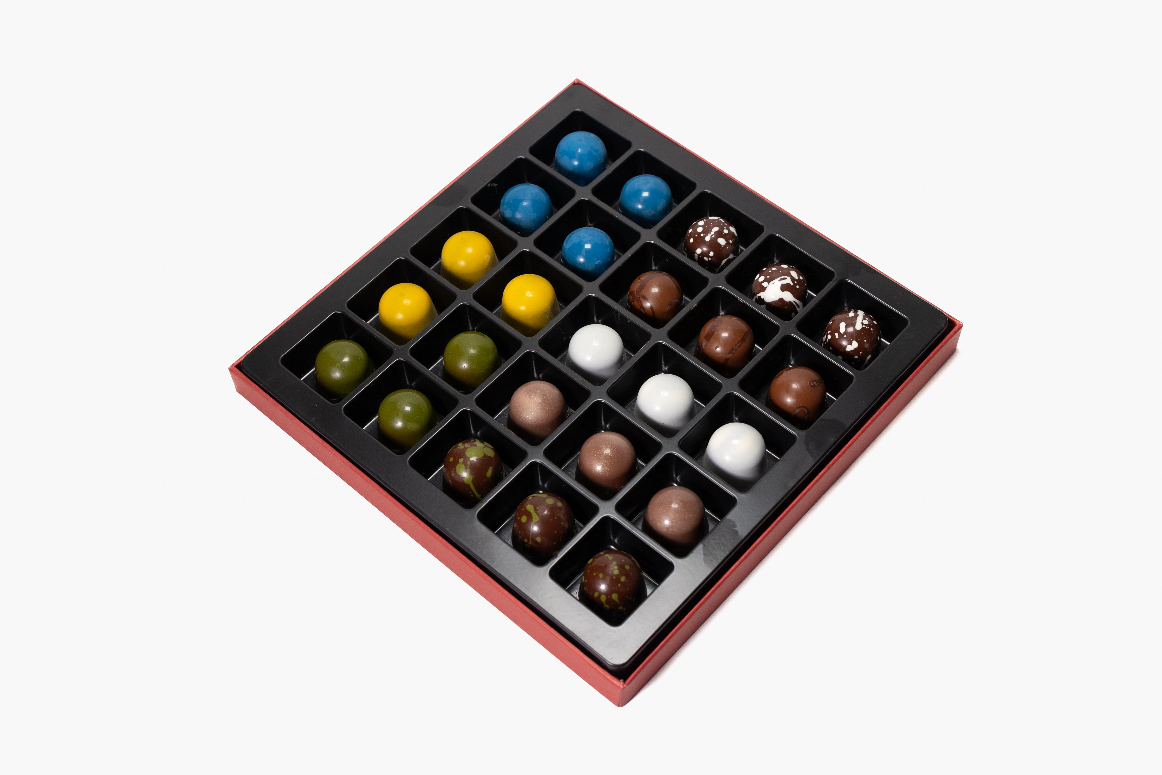 Assorted colorful chocolates in a grid on a white background