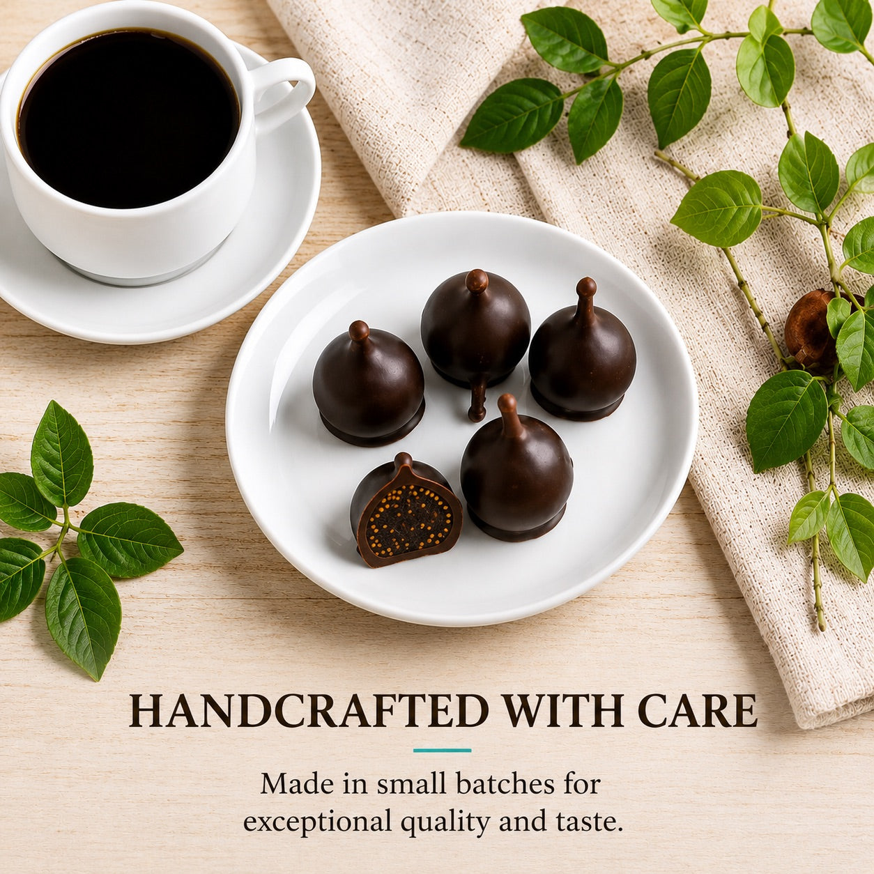 Chocolate truffles on a plate with a cup of coffee and green leaves on a wooden surface.