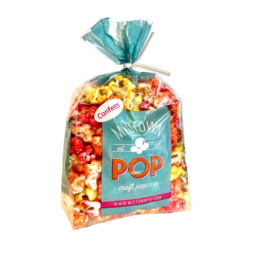 Bag of Midtown Pop "Autumn" Confetti gourmet popcorn in a clear gift bag with colorful red, yellow, orange, and white popcorn on a white background.