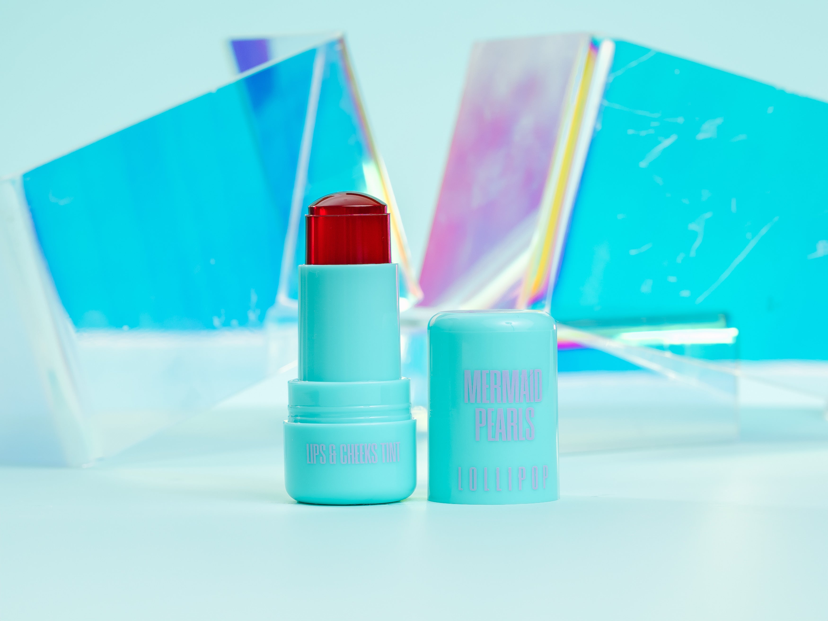 Mermaid Pearls LOLLIPOP Berry Lip & Cheek Tint in aqua twist-up tube with translucent berry jelly formula, buildable rosy color for lips and cheeks, hydrating vegan, cruelty-free clean beauty makeup.