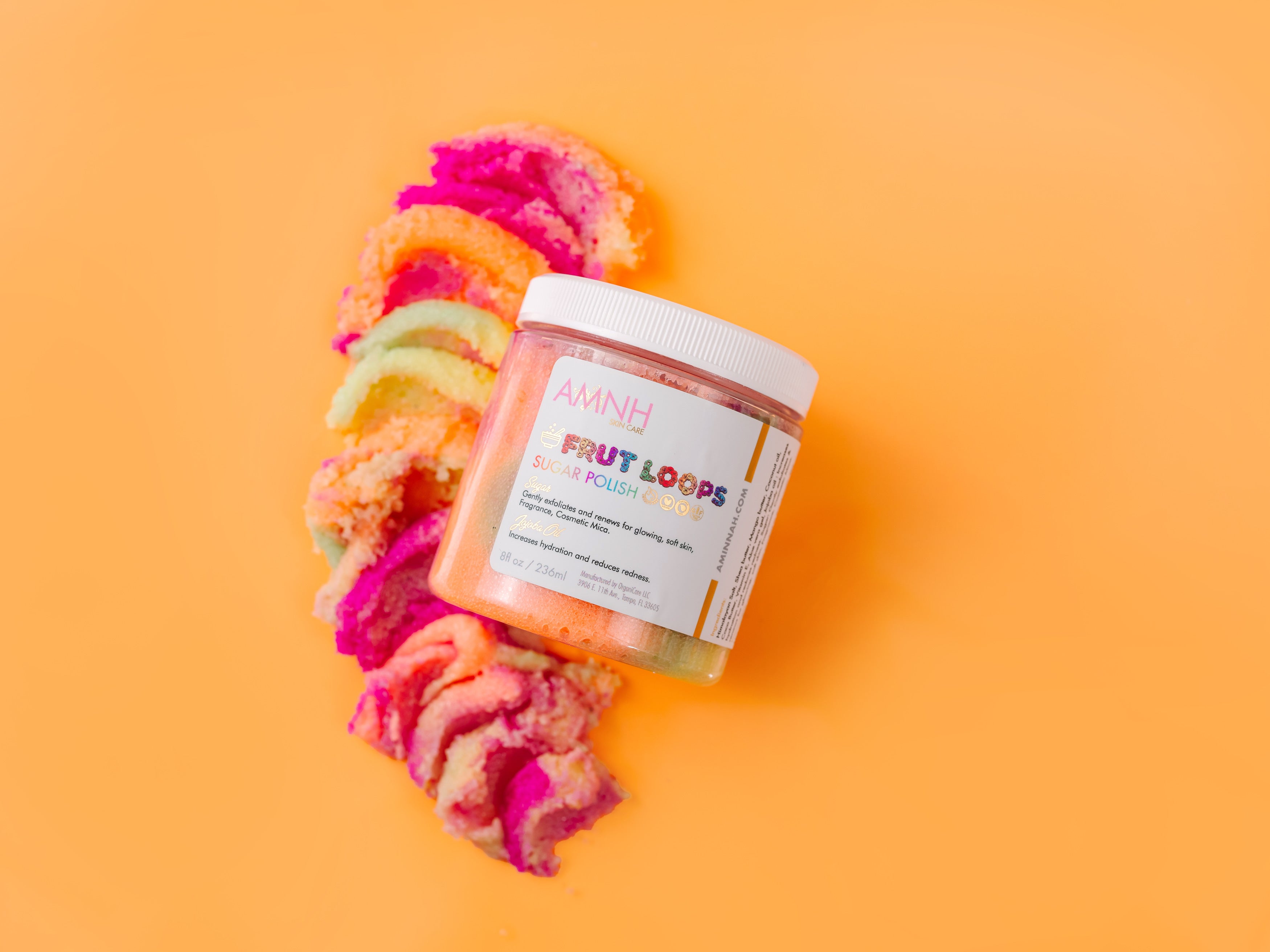 AMINNAH Frut Loops Sugar Scrub made with real sugar, shea butter, mango butter, cocoa butter, coconut oil, jojoba oil, aloe vera, and vitamin E. Fruity scented exfoliating body scrub for soft, smooth, hydrated skin from a female-owned clean beauty brand.