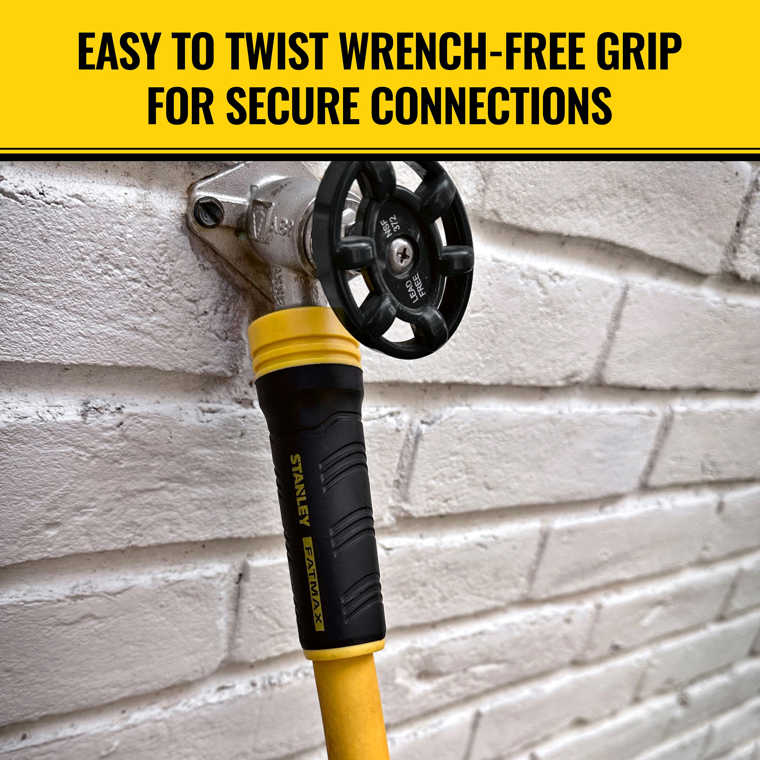 Stanley hose tool with yellow and black handle on a brick wall background. easy to twist wrench-free grip for secure connections.