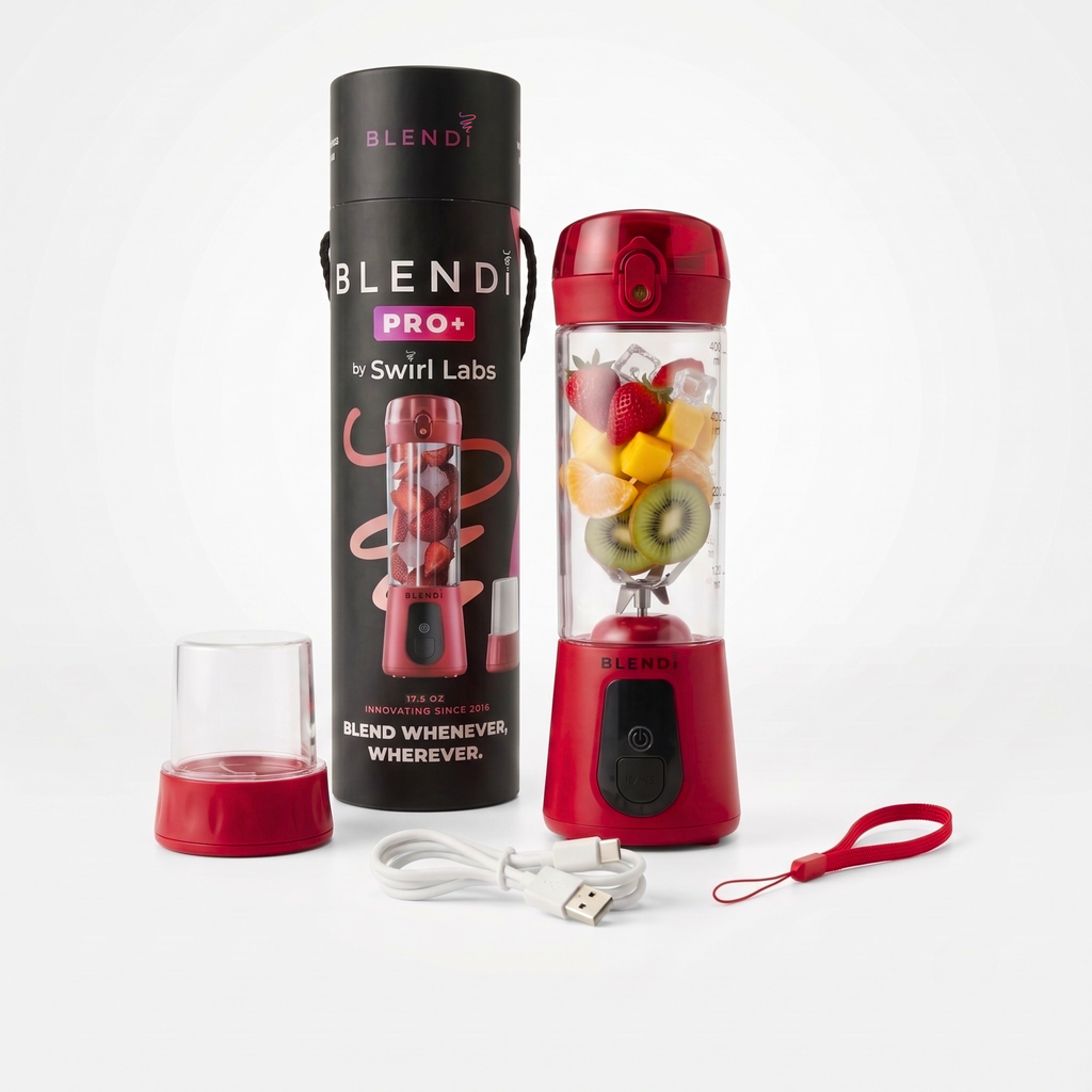 A red portable blender bottle with a clear container filled with fruit, shown beside its tall black cylindrical packaging tube, a small clear cup with a red base, a white USB charging cable, and a red wrist strap on a light gray background.