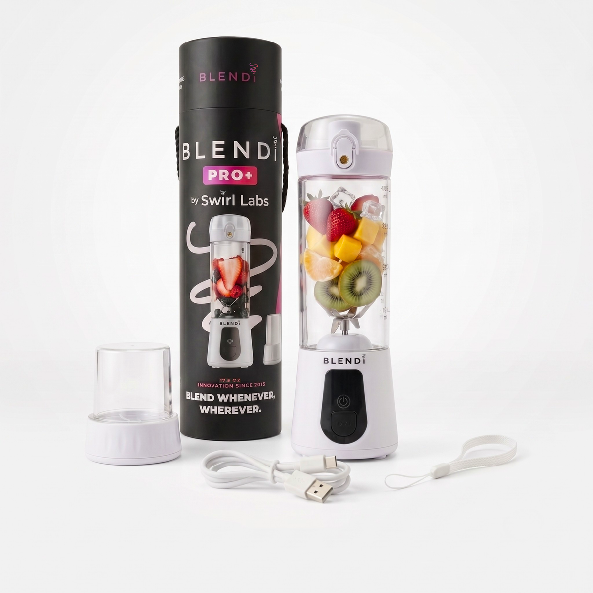 Blendi Pro+ portable blender by Swirl Labs shown with its black cylindrical packaging, clear travel cup, USB charging cable, and carrying strap on a clean white background. The blender jar is filled with fruit pieces.