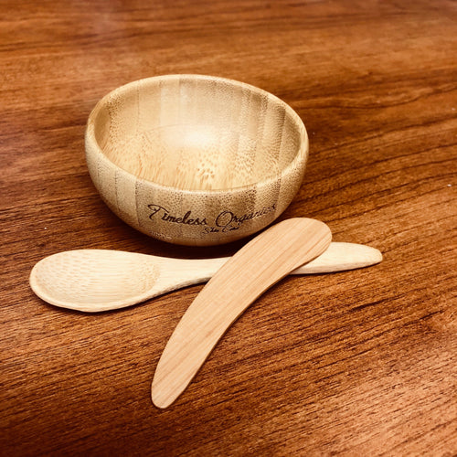 Wooden bowl and spoons on a wooden surface with 'Timeless Organics' branding.