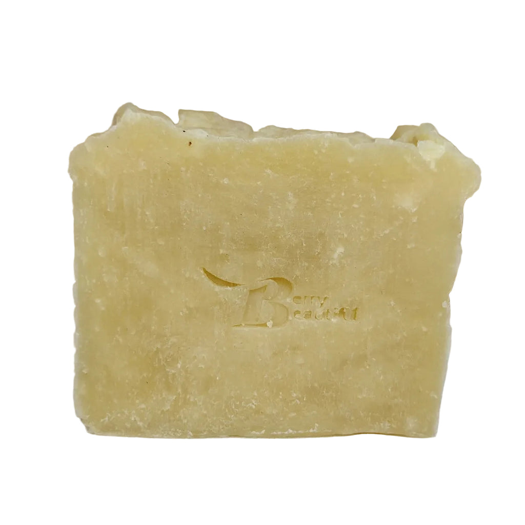 Bar of soap with a brand logo on a white surface with straw in the background