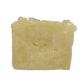 Bar of soap with a brand logo on a white surface with straw in the background