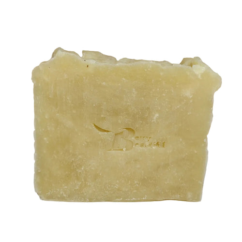 Bar of soap with a brand logo on a white surface with straw in the background