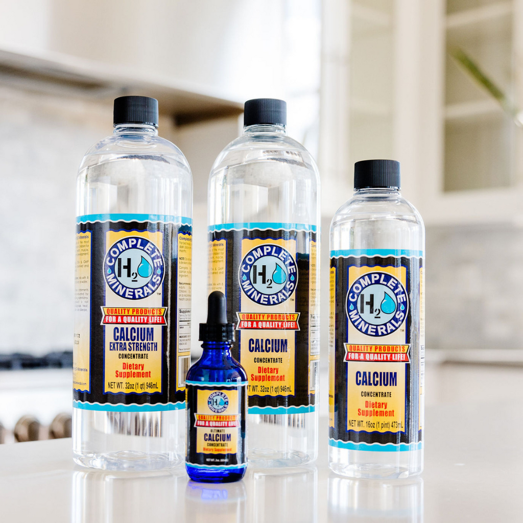 Three bottles of Complete Minerals Calcium product on a kitchen counter.