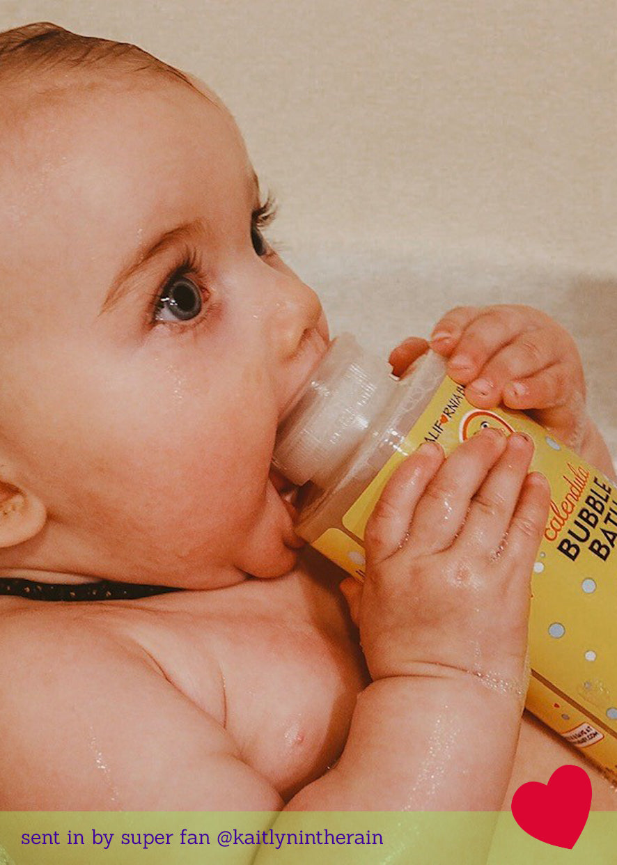 Baby drinking from a bottle with a vintage filter applied California Baby Calendula™ Bubble Bath | Plant-Based Gentle Baby Bubble Bath | USDA Certified Biobased