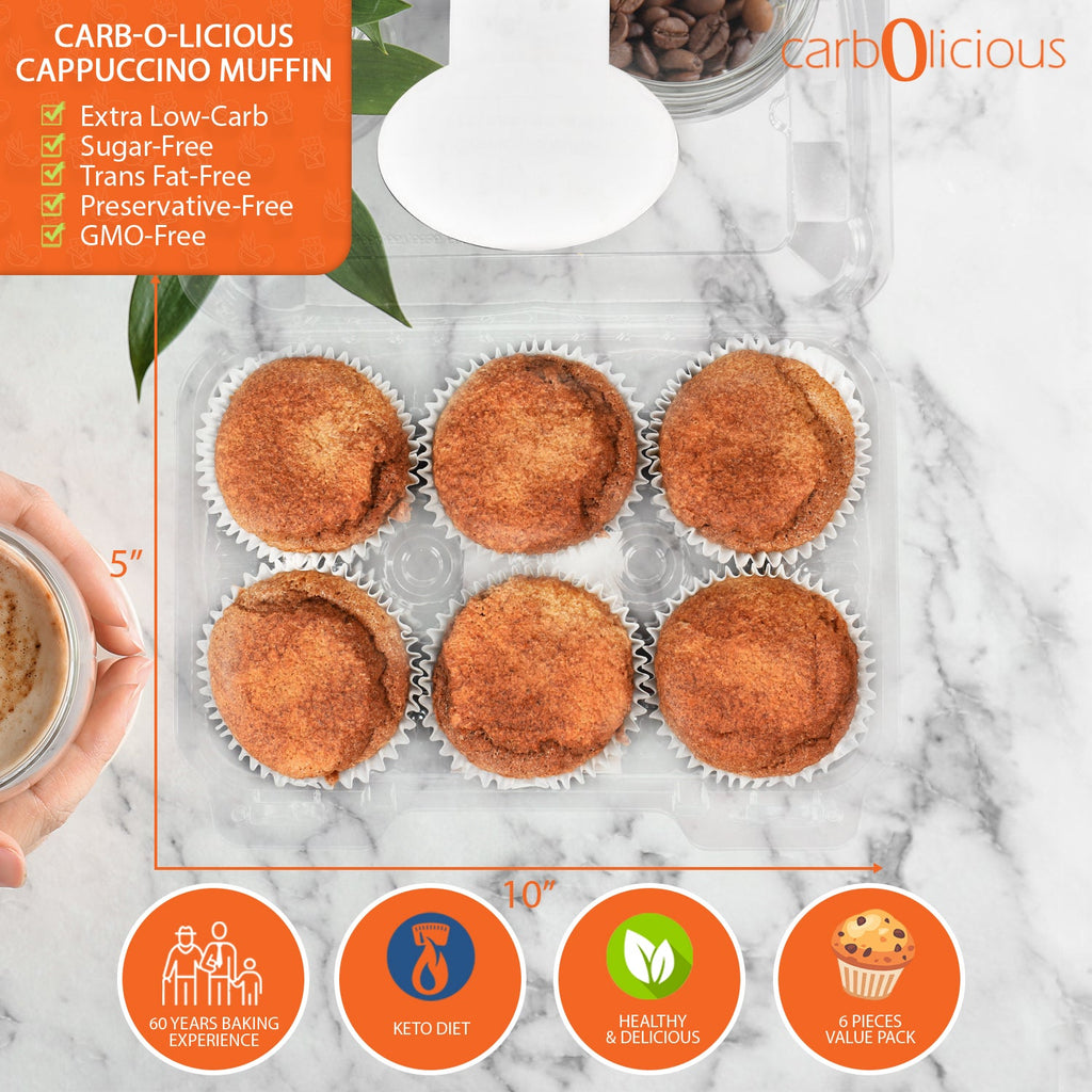 Carb-O-Licious Cappuccino Muffins in a 6-pack container showcasing extra low-carb, sugar-free, keto-friendly muffins with 2g net carbs per serving, preservative-free, GMO-free, and trans fat-free on a marble countertop beside a cappuccino cup.