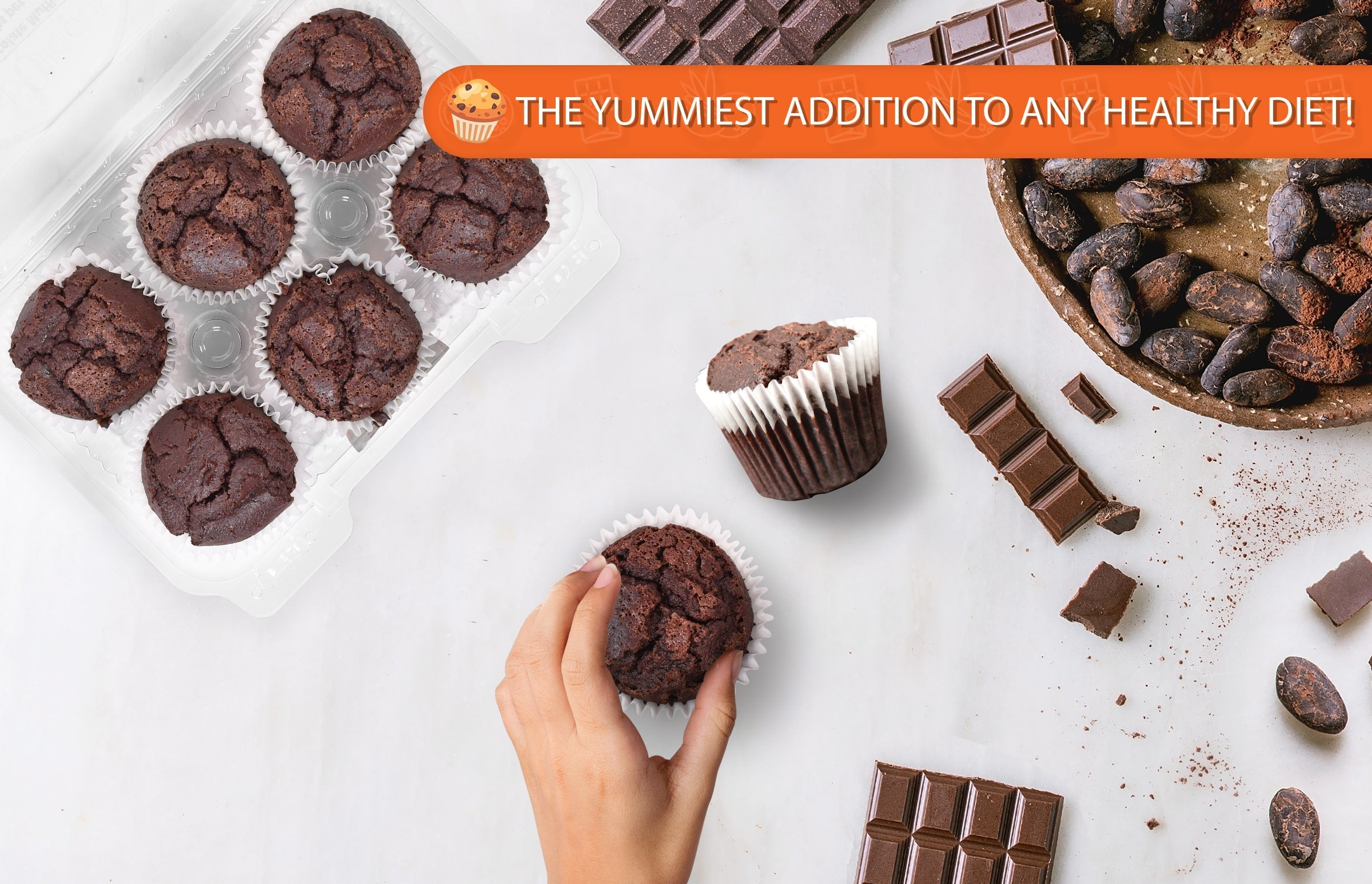 Low-carb sugar-free chocolate muffins arranged in a six-pack with one muffin held in hand, surrounded by chocolate bars and cacao beans on a white background, highlighting a rich, healthy bakery treat.