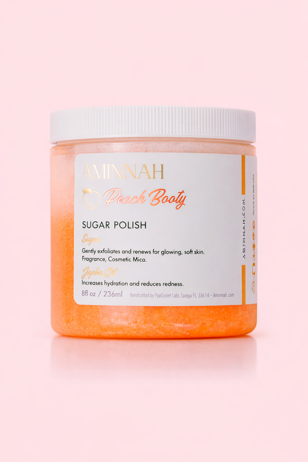 Sugar polish AMINNAH "Peach Booty" Tightening & Lifting Butt Butter in an 8 oz jar displayed against a soft peach background. This luxurious whipped body butter is formulated with peach extract, retinol, vitamin C, vitamin E, shea butter, cocoa butter, coconut oil, jojoba oil, sweet almond oil, and apricot kernel oil to help hydrate, nourish, smooth, and improve the appearance of firmer-looking skin. Clean beauty, cruelty-free, vegan, made with naturally derived ingredients, and crafted by a female-owned