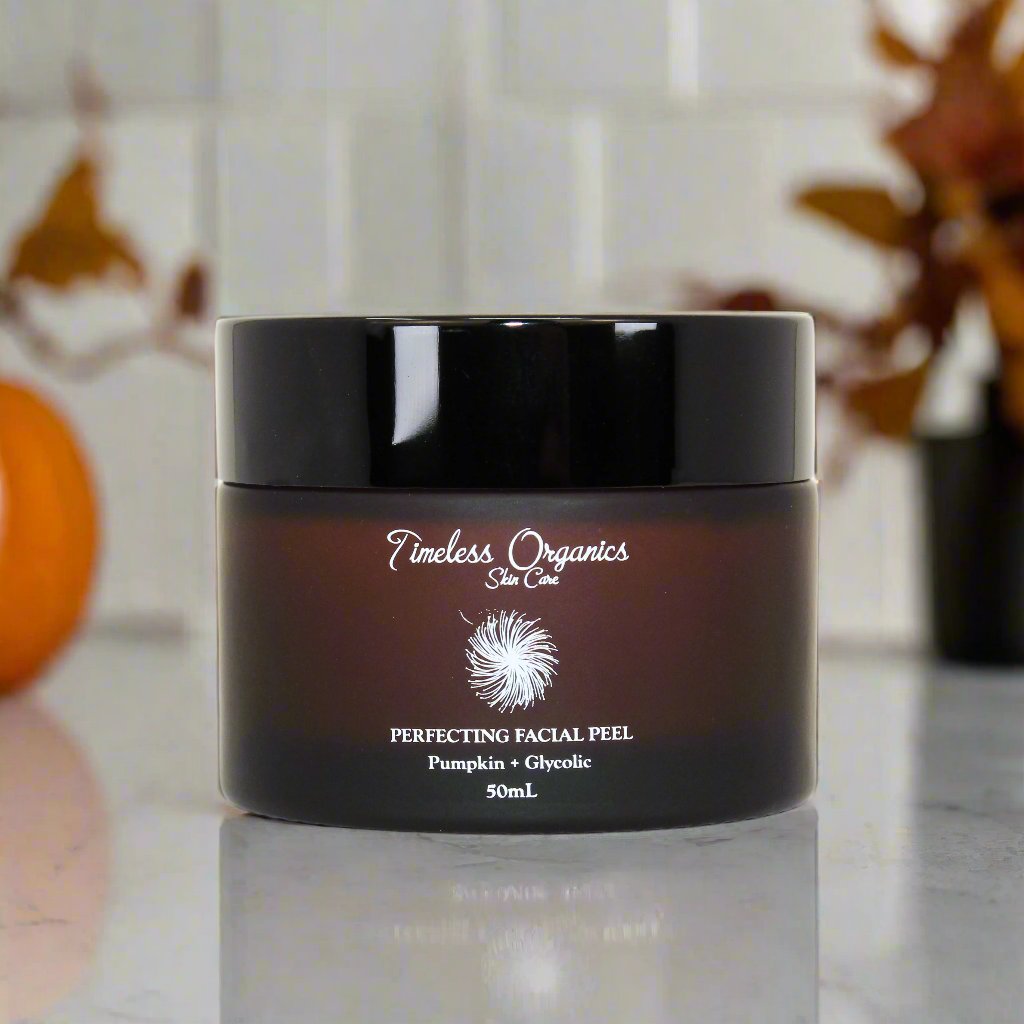Jar of Timeless Organics Perfecting Facial Peel on a reflective surface with a blurred background