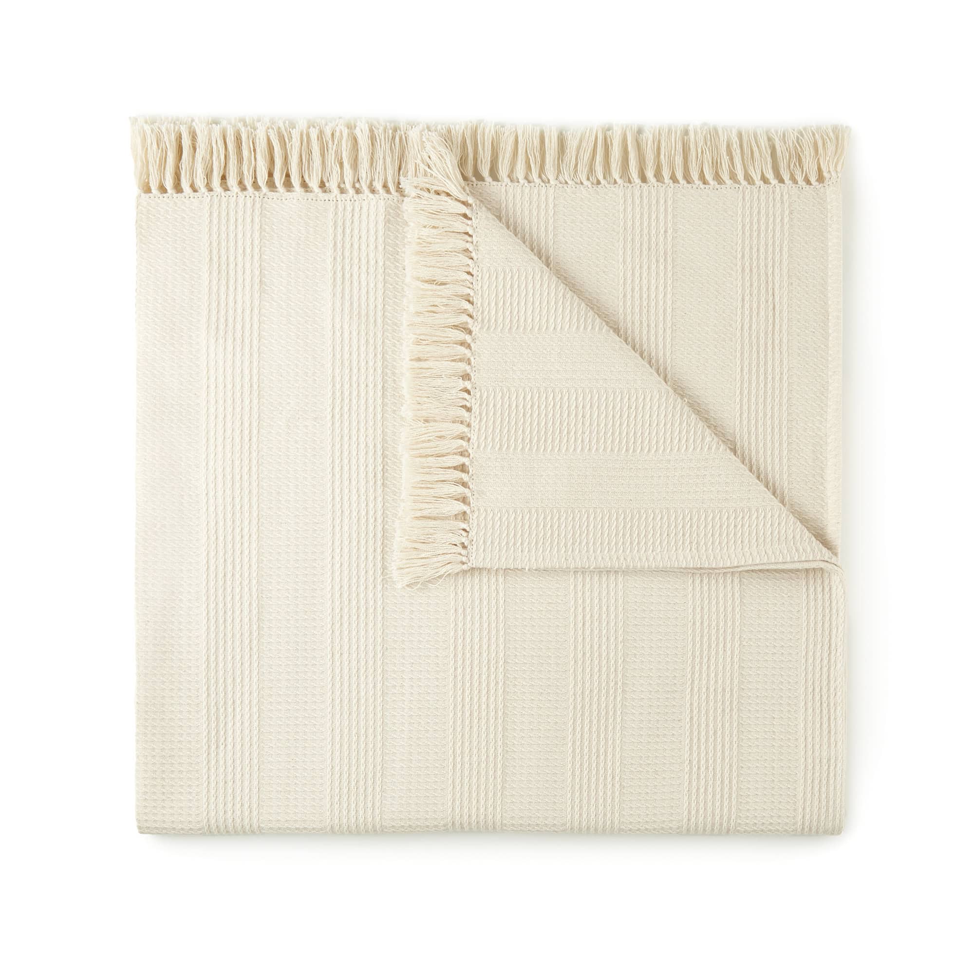 Beige textured blanket on a white background. Organic Cotton Throw with Tassels