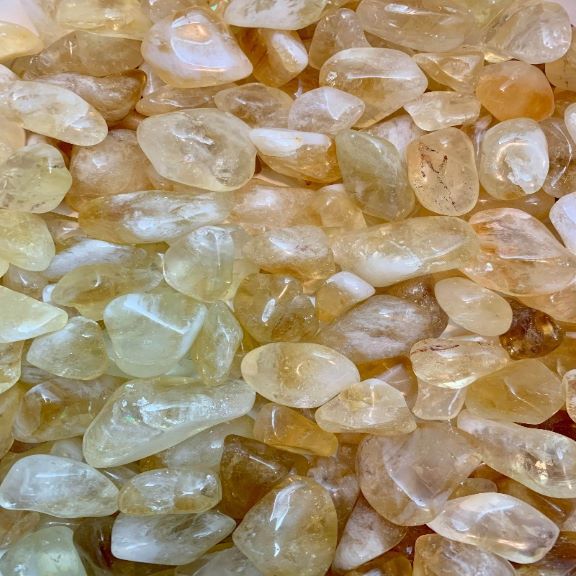 Natural citrine crystal tumbled stones in golden yellow quartz tones for crystal healing, manifestation, abundance, meditation, spiritual wellness and crystal lover gifts.