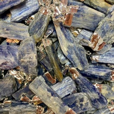 Blue kyanite crystal pendant necklace with natural raw gemstone, silver-tone wire-wrapped setting, spiritual healing jewelry and metaphysical gift.