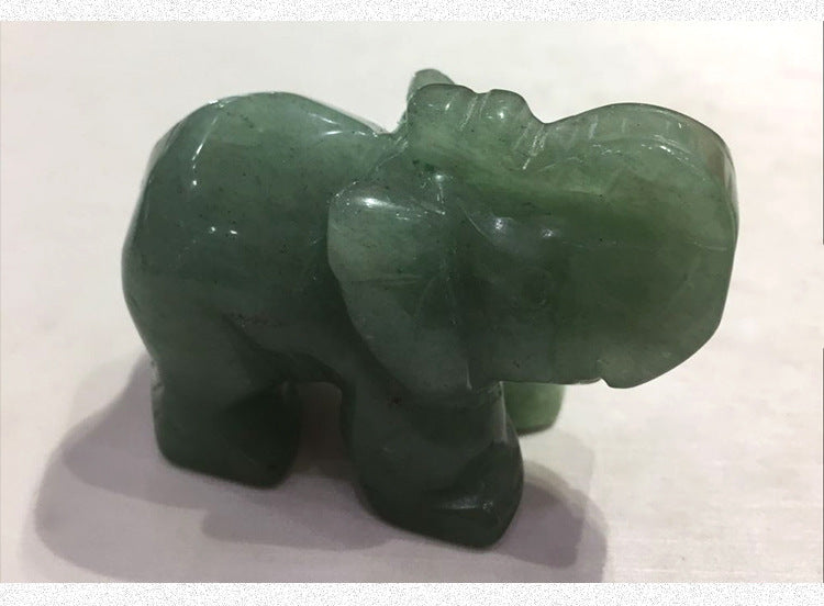 Green jade elephant figurine on a white background