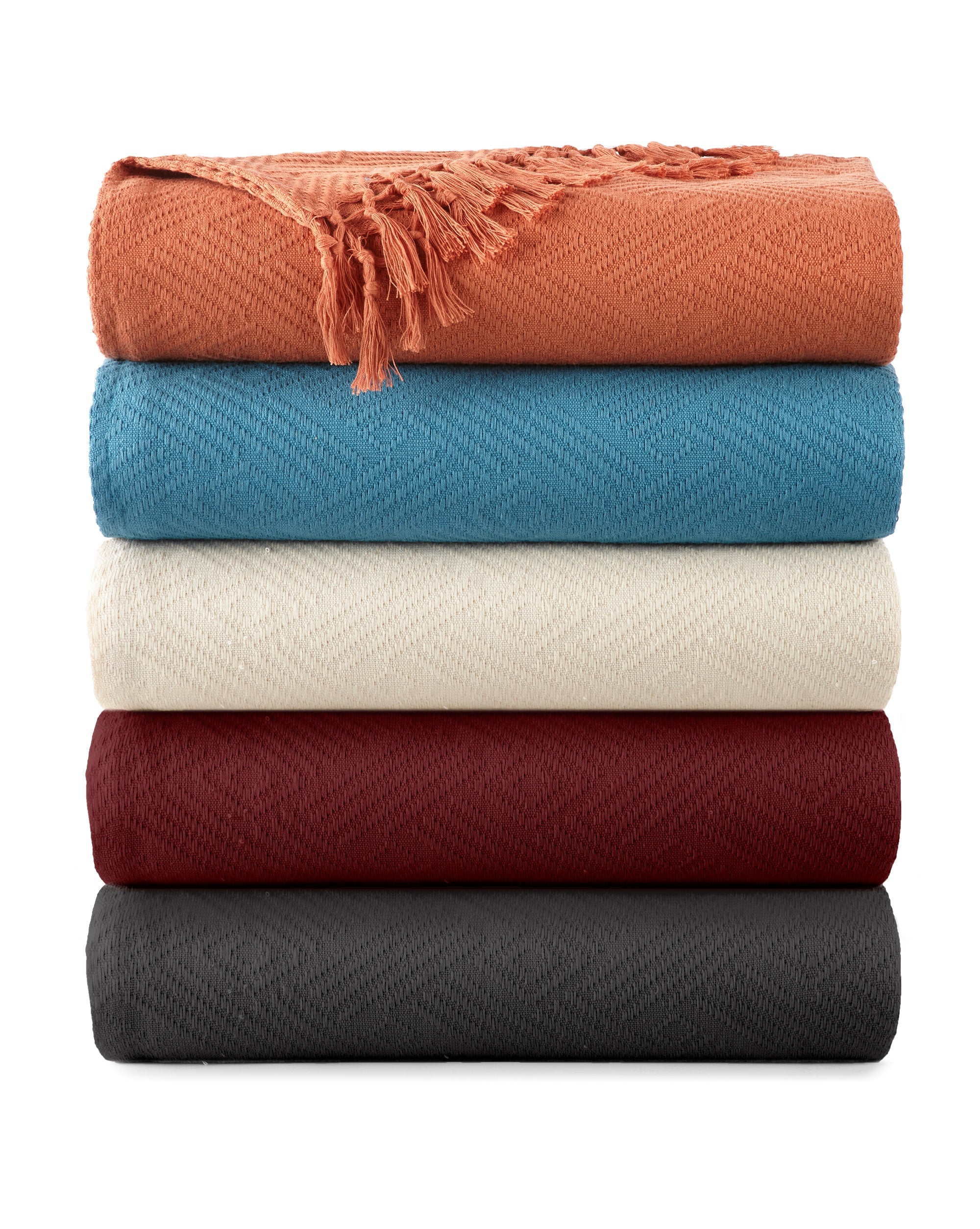 Stack of five folded blankets in various colors on a white background. Diamond Jacquard Throw Rust