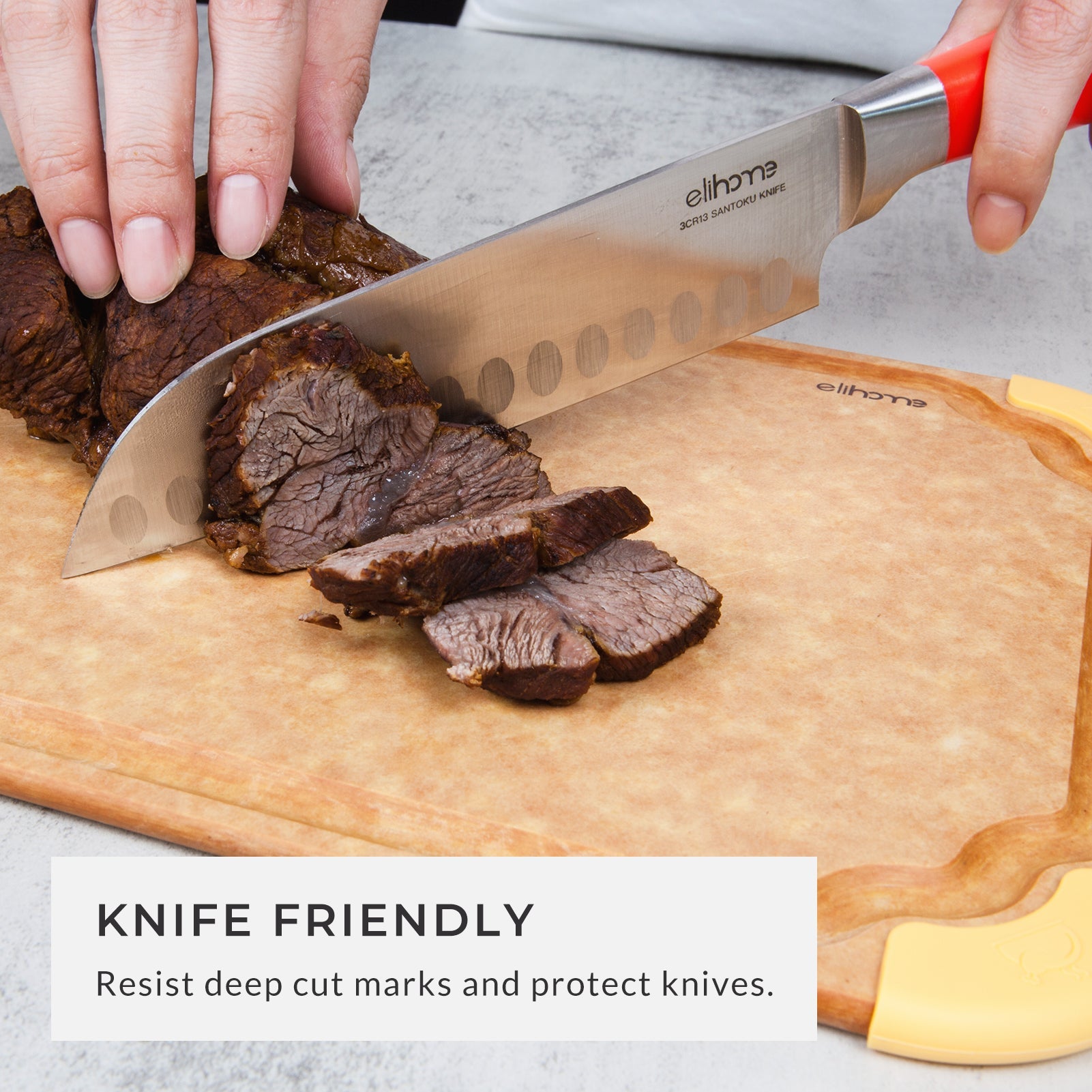 Chef's knife slicing cooked beef roast on a knife-friendly, non-slip color-coded cutting board, demonstrating a durable medium cutting board that resists deep cut marks and helps protect knife blades during food preparation.