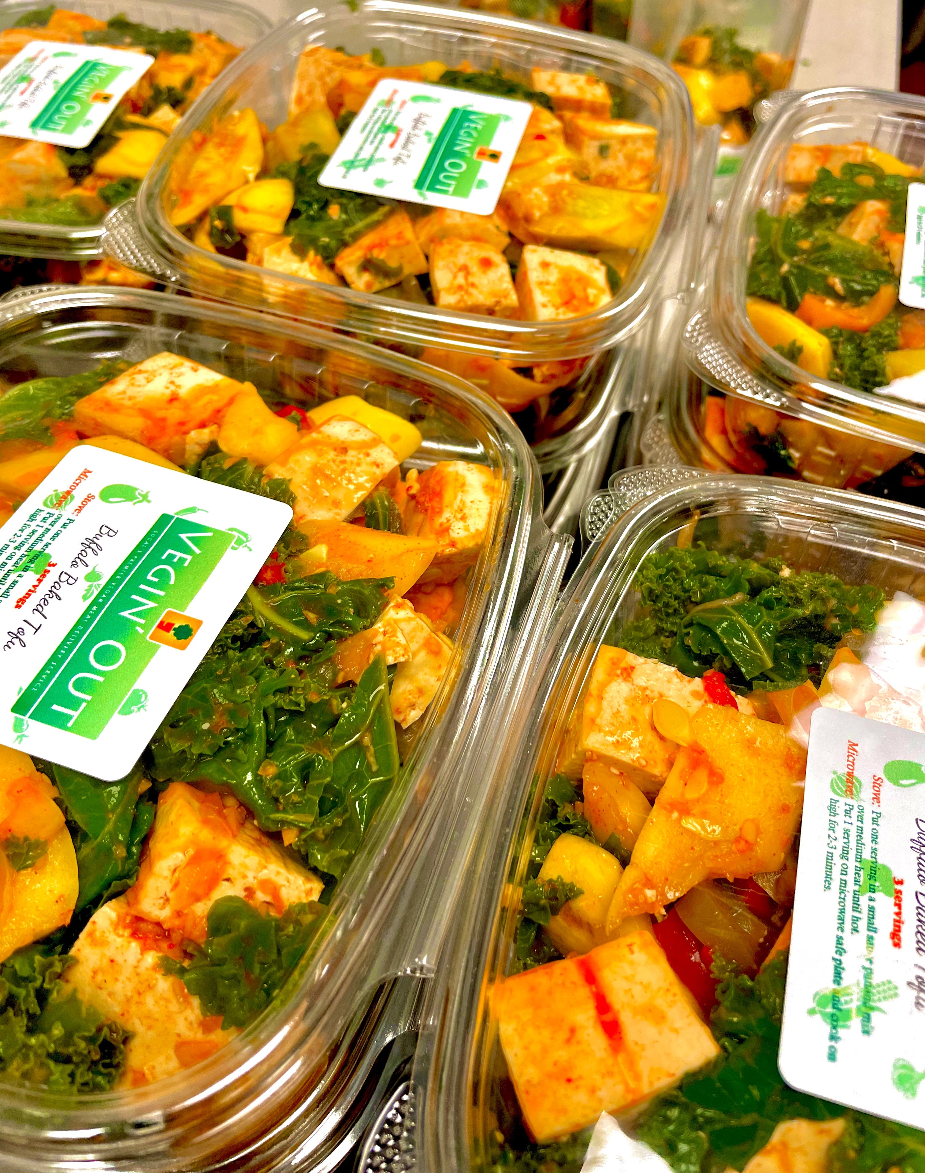 Fresh plant-based vegetarian and vegan entrée featuring seasoned tofu, fresh kale, colorful vegetables, and wholesome ingredients in ready-to-eat meal containers by Vegin' Out, available at Tree of Life Grocers.