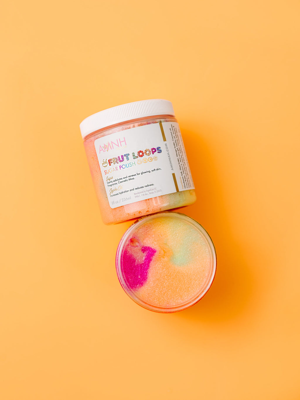 AMINNAH Frut Loops Sugar Scrub made with real sugar, shea butter, mango butter, cocoa butter, coconut oil, jojoba oil, aloe vera, and vitamin E. Fruity scented exfoliating body scrub for soft, smooth, hydrated skin from a female-owned clean beauty brand.