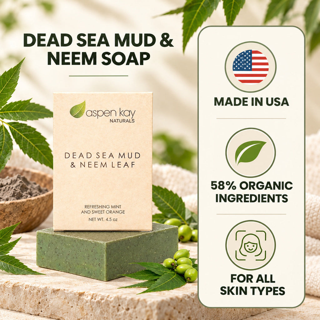 Aspen Kay Naturals Dead Sea Mud & Neem Leaf soap bar displayed on a stone surface with hemp leaves and a vertical badge listing benefits like Made in USA, 58% Organic Ingredients, and suitability for all skin types.