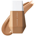 Fenty Beauty foundation bottle with a swatch of the product on a white background. FENTY BEAUTY Eaze Drop: Blurring Skin Tint - Lightweight, Buildable Light Coverage Foundation for Natural Finish, Vegan & Cruelty-Free, Sweat-Resistant