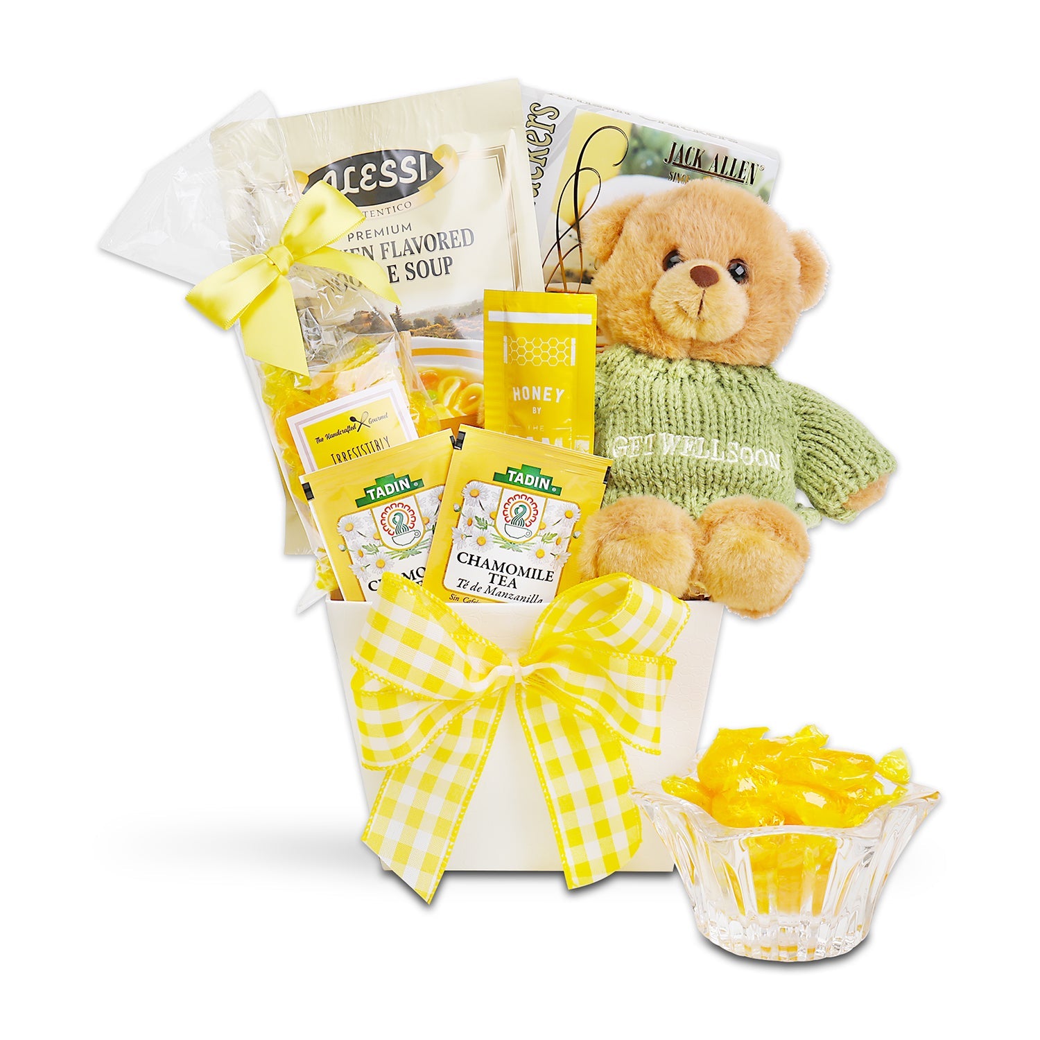 Gift basket with teddy bear, tea packages, and candy on a white background. Hugs & Well Wishes Gift Basket: Alessi Premium Chicken Flavored Noodle Soup, Artisan Olive Oil & Sea Salt Crackers, Butterscotch Candy, Chamomile Tea, 2 Honey Sticks, Plush Teddy Bear with “Get Well Soon” Sweater