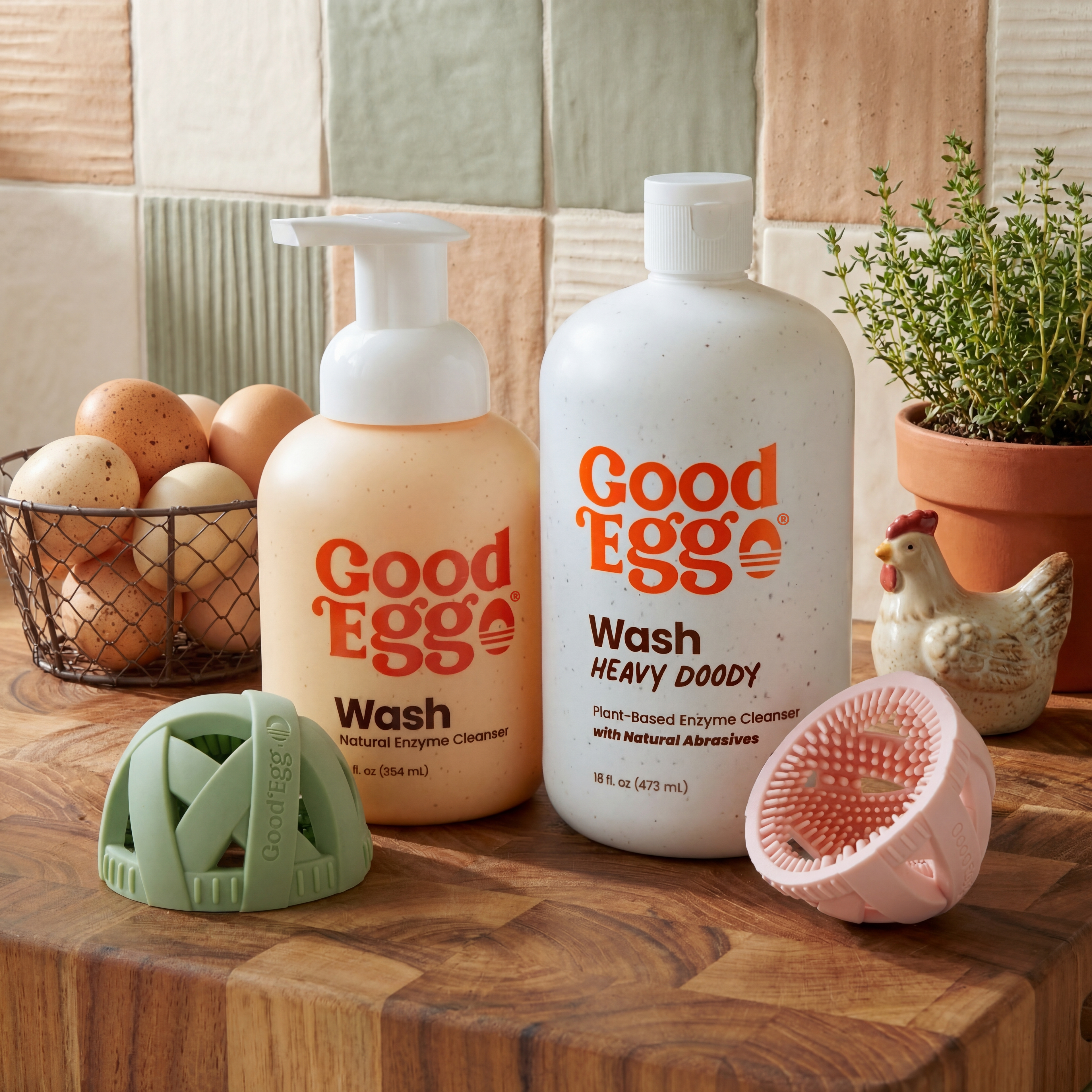 Two bottles of 'Good Eggo' wash on a wooden surface with kitchen items in the background.