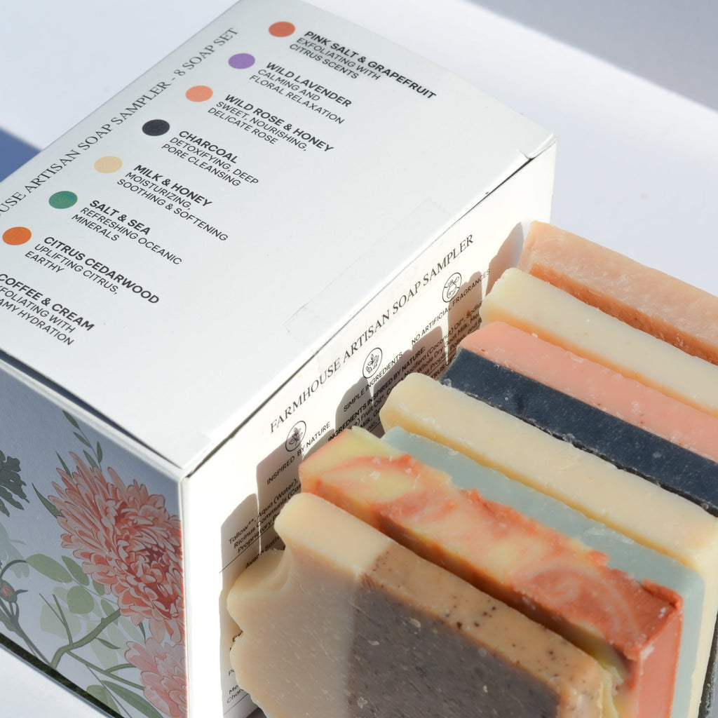 Set of artisan soap bars with a box displaying various soap options.