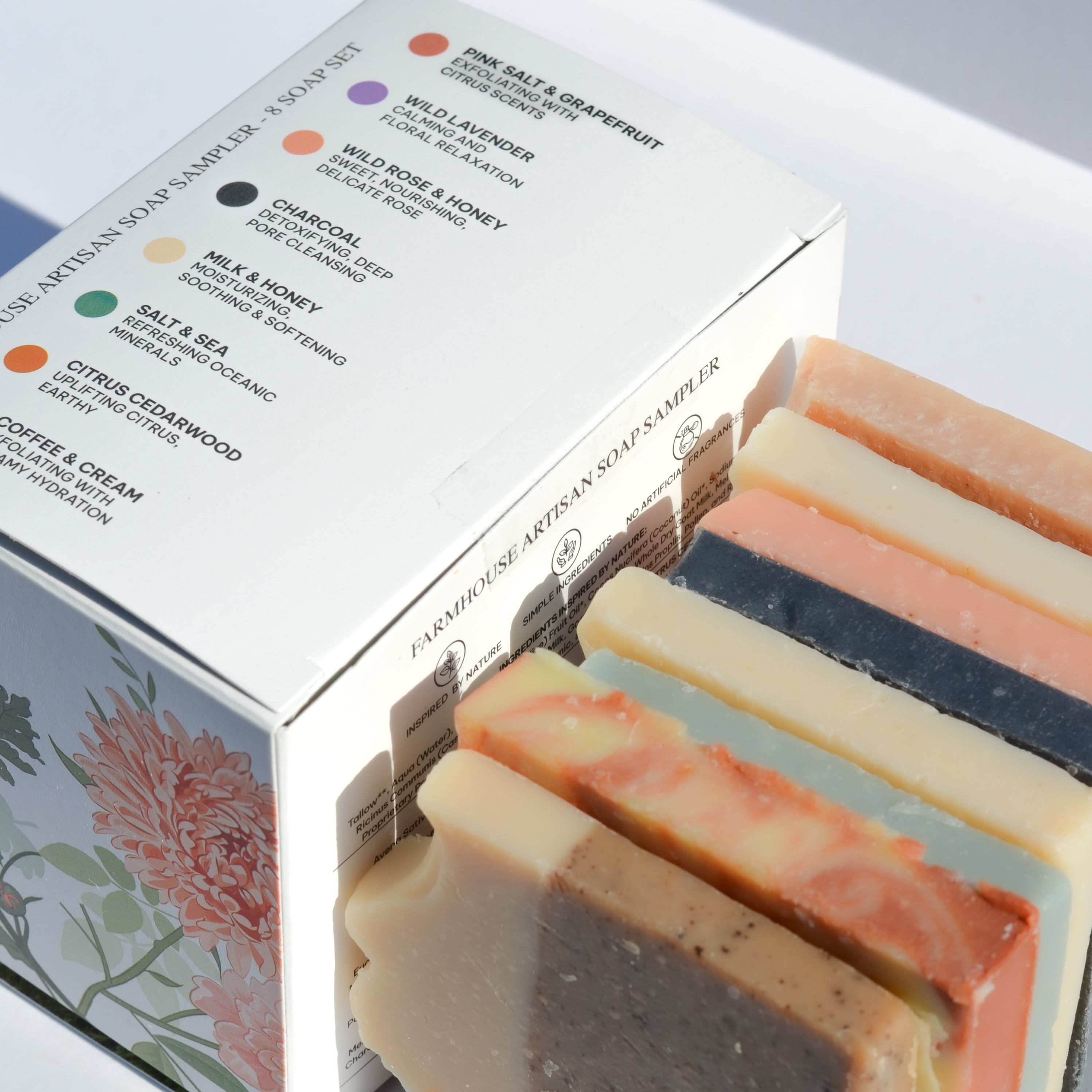 Set of artisan soap bars with a box displaying various soap options.